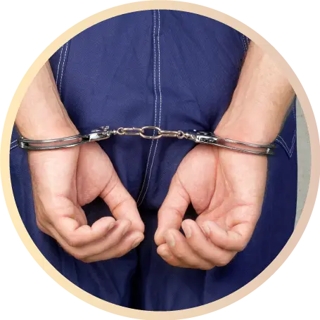 close up of mans hands in handcuffs behind his back